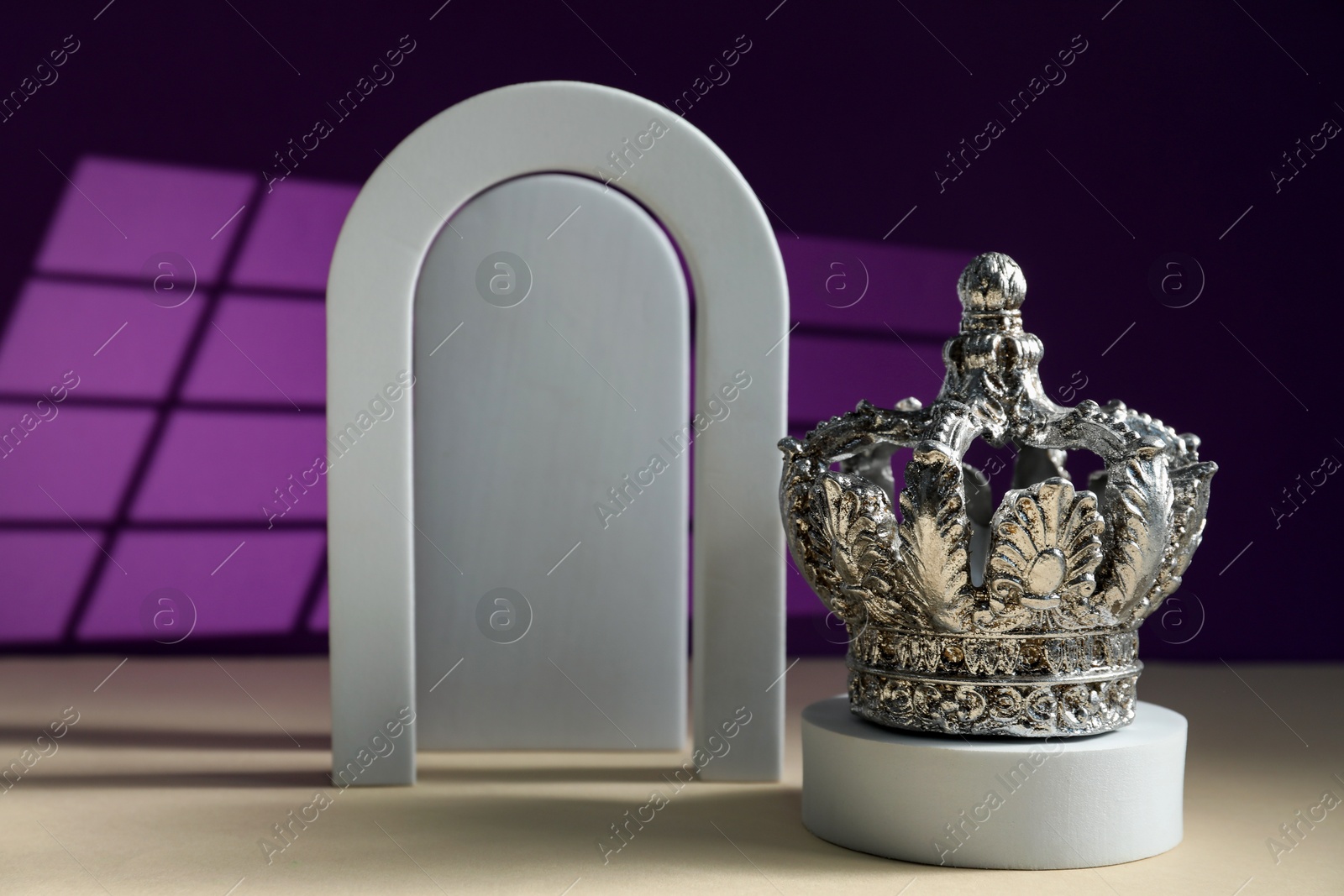 Photo of Different geometric shapes and silver crown on color background