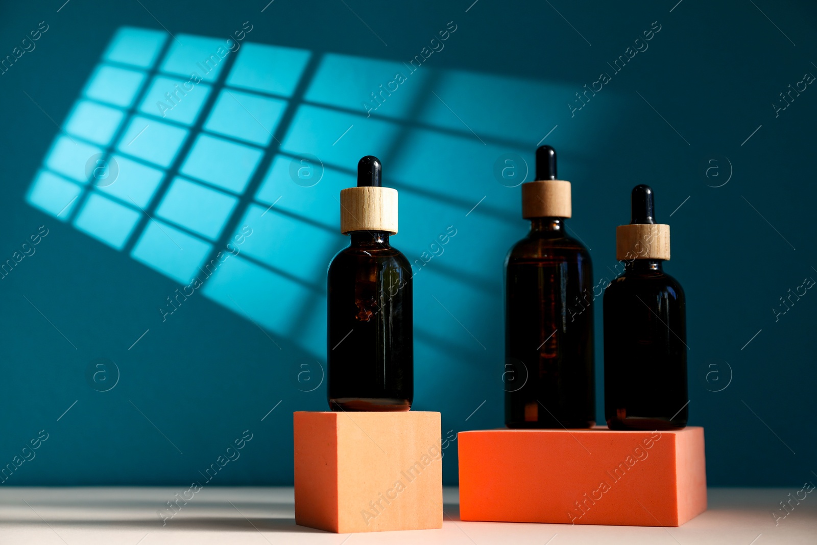 Photo of Bottles of cosmetic product on color background, space for text