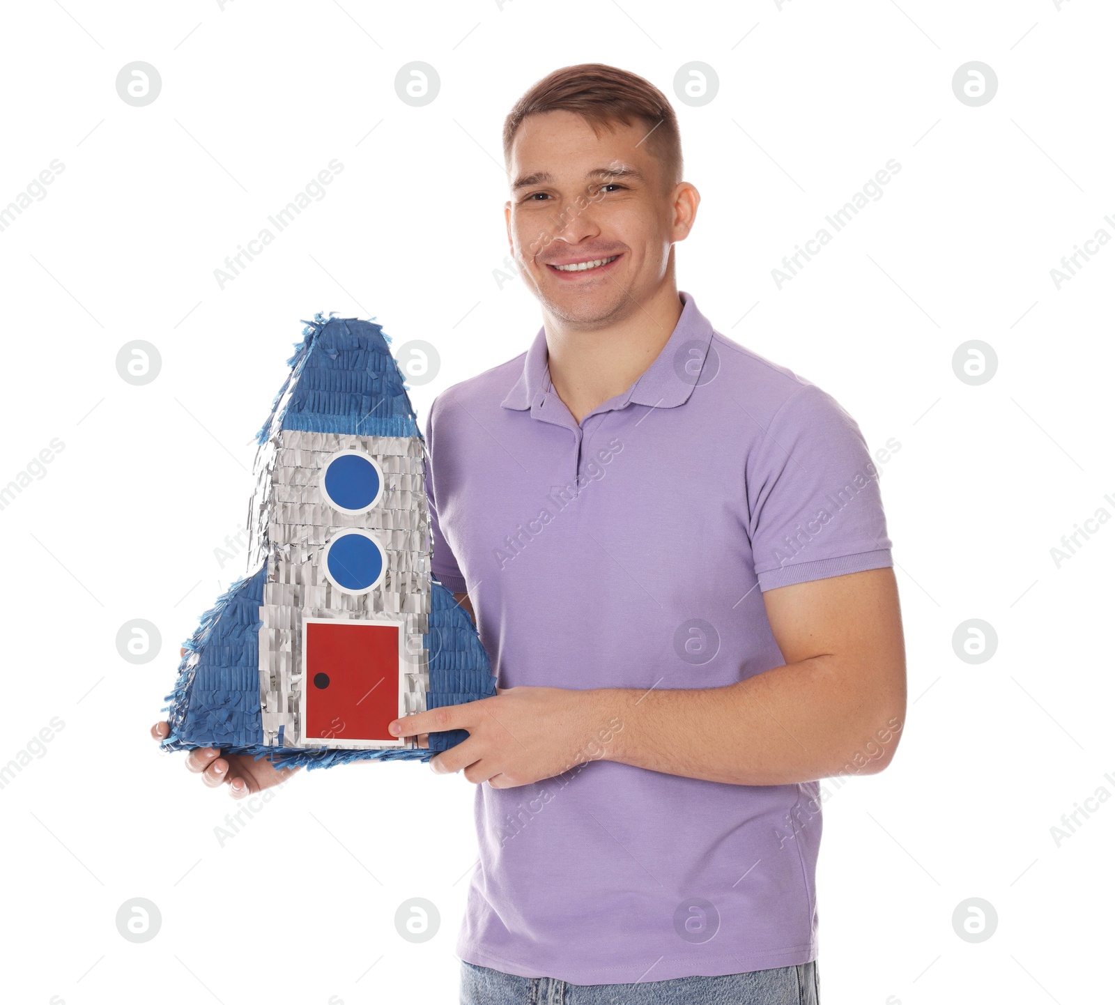 Photo of Happy man with pinata in shape of spaceship on white background