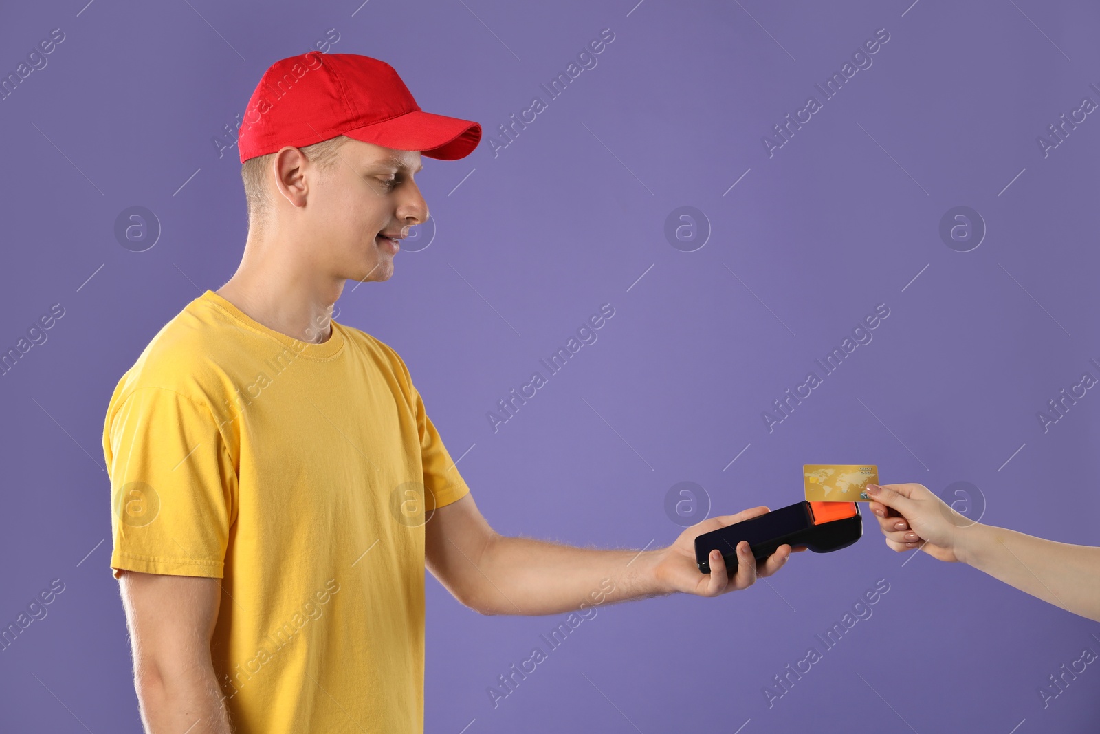 Photo of Courier taking payment from client via terminal on purple background