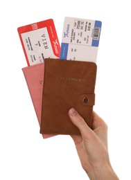 Photo of Travel agency. Woman holding flight tickets and passports on white background, closeup