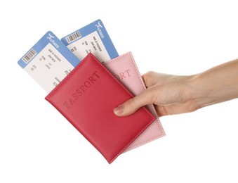 Photo of Travel agency. Woman holding flight tickets and passports on white background, closeup