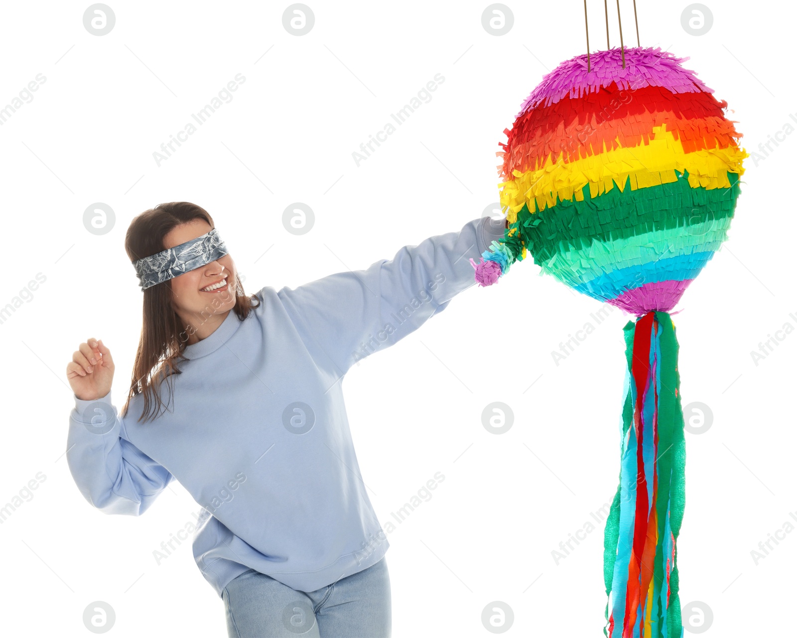 Photo of Woman with tied eyes breaking pinata on white background