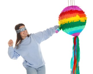 Photo of Woman with tied eyes breaking pinata on white background