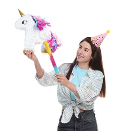 Photo of Happy woman with unicorn shaped pinata and stick on white background