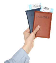 Photo of Woman holding passports with tickets on white background, closeup