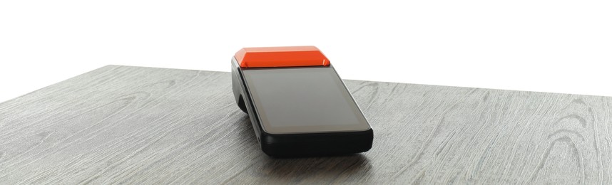 Photo of Payment terminal on wooden table against white background