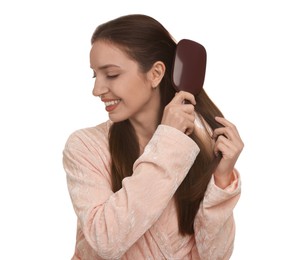 Photo of Smiling woman brushing her hair on white background