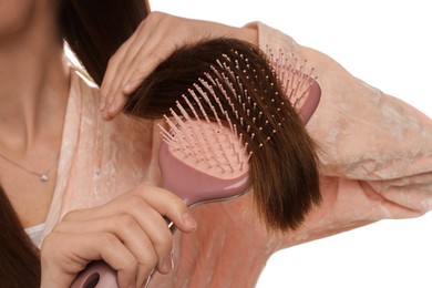 Photo of Woman brushing her hair on white background, closeup