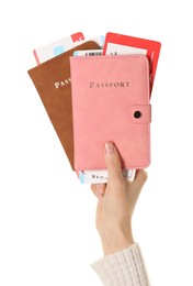 Photo of Woman holding passports with tickets on white background, closeup