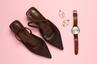 Photo of Stylish shoes, earrings and watch on pink background, flat lay