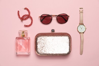 Photo of Stylish jewelry, perfume and accessories on pink background, flat lay