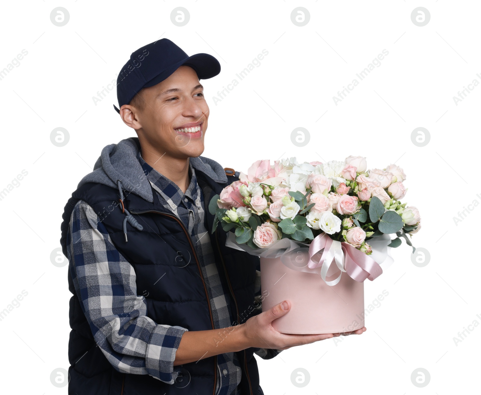 Photo of Smiling delivery man holding gift box with beautiful floral composition on white background