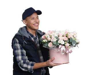 Photo of Smiling delivery man holding gift box with beautiful floral composition on white background