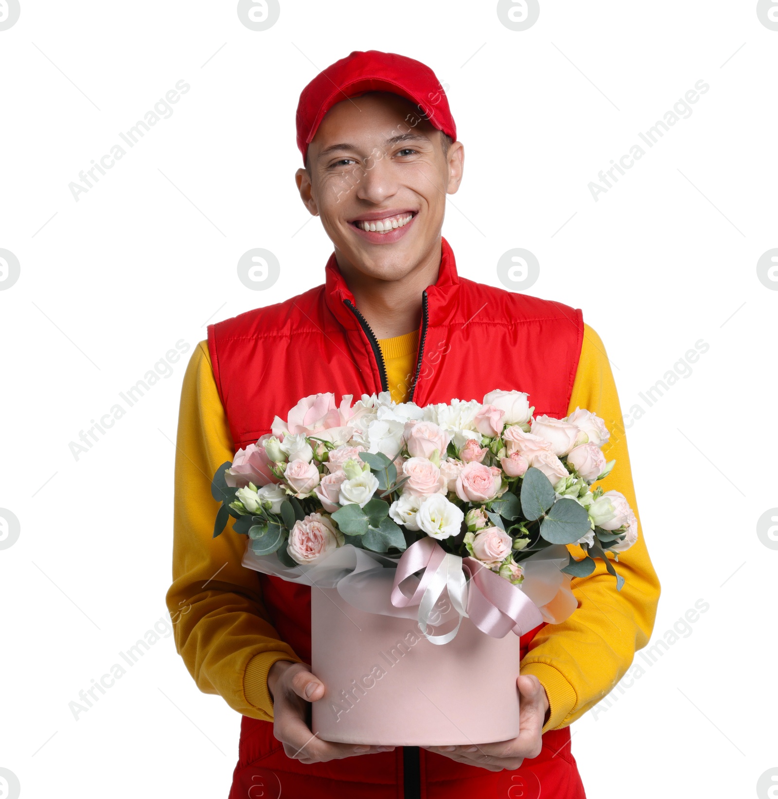 Photo of Smiling delivery man holding gift box with beautiful floral composition on white background