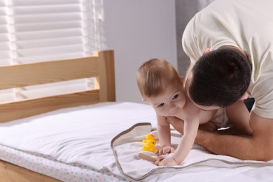 Photo of Father with his cute little baby indoors, space for text