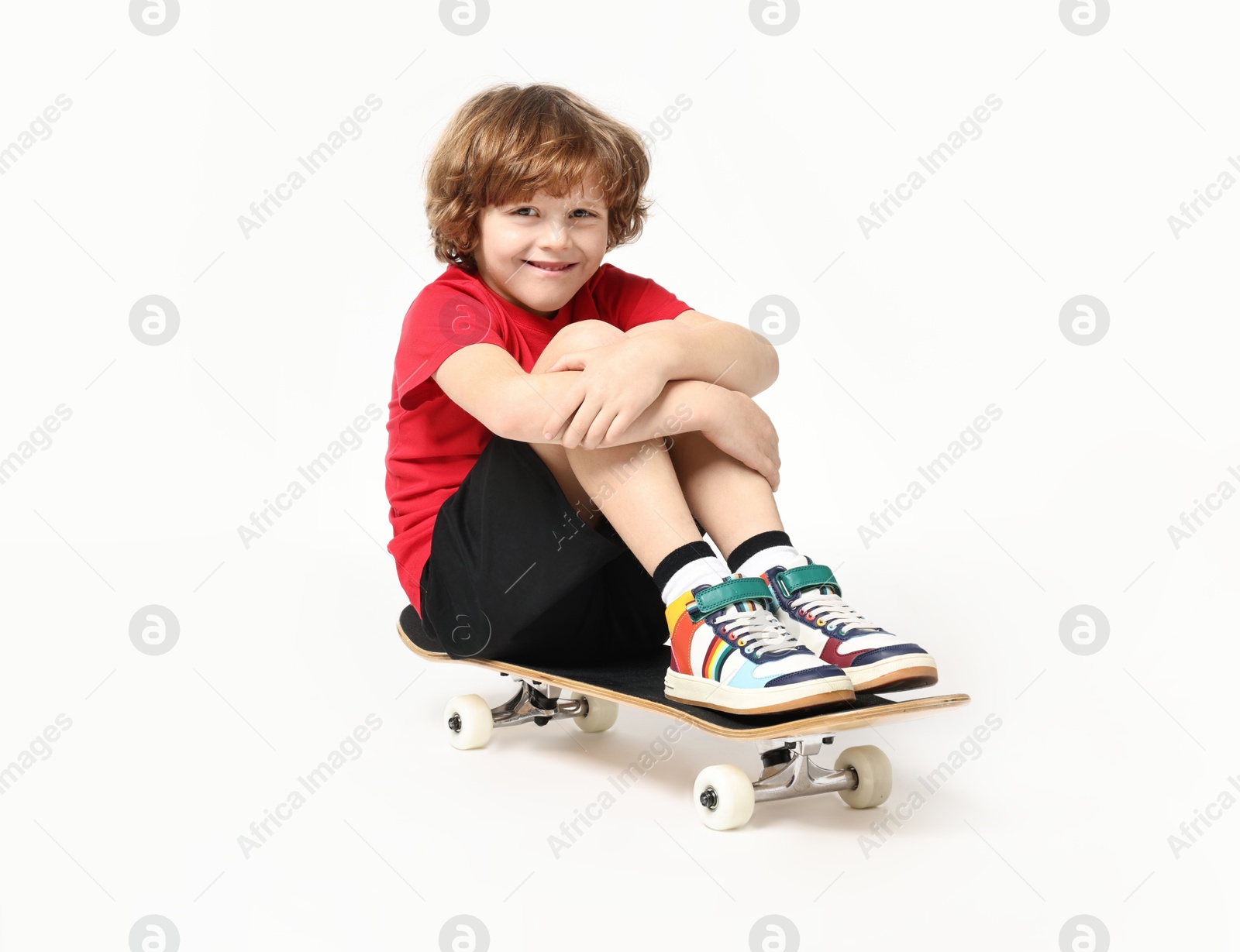 Photo of Little boy with skateboard on white background