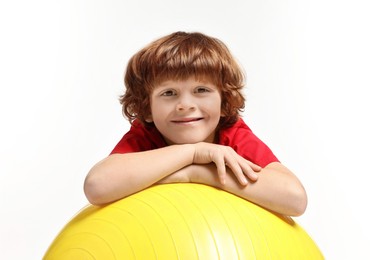 Little boy with fitness ball on white background