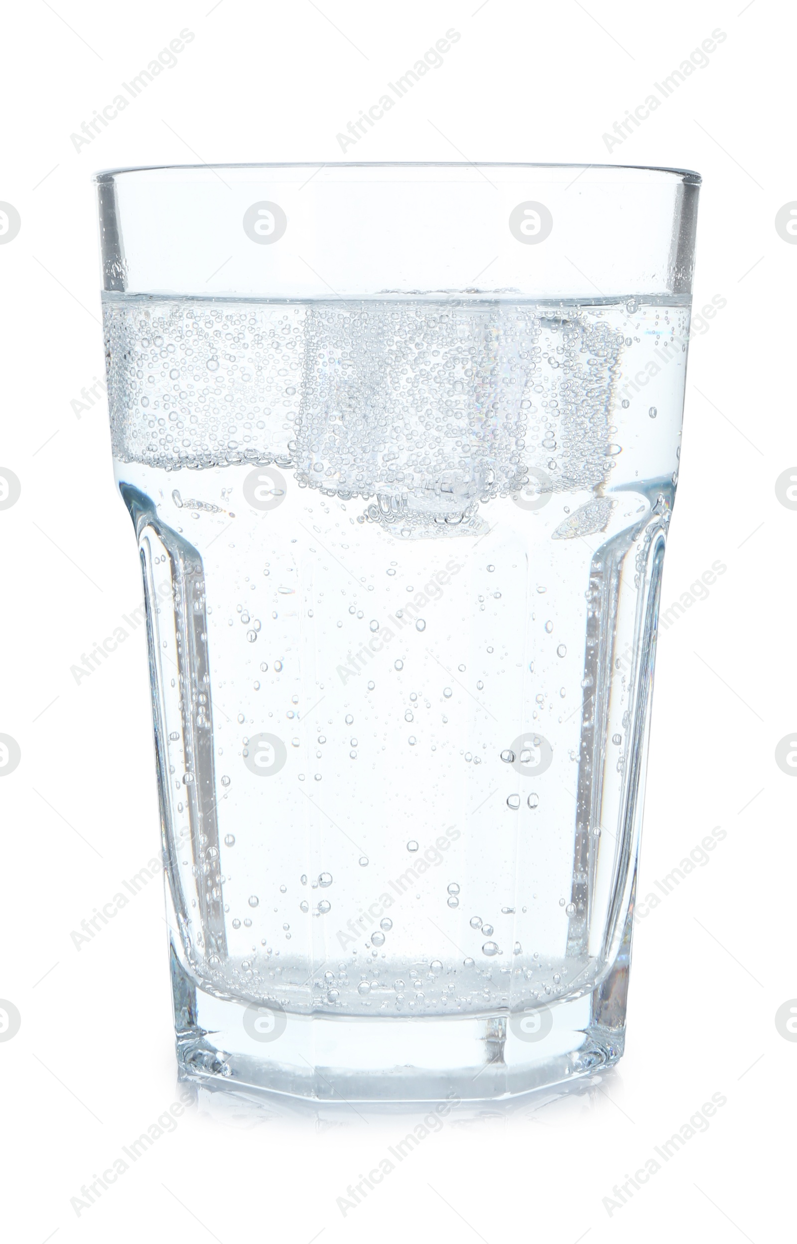 Photo of Glass of refreshing soda water with ice cubes isolated on white