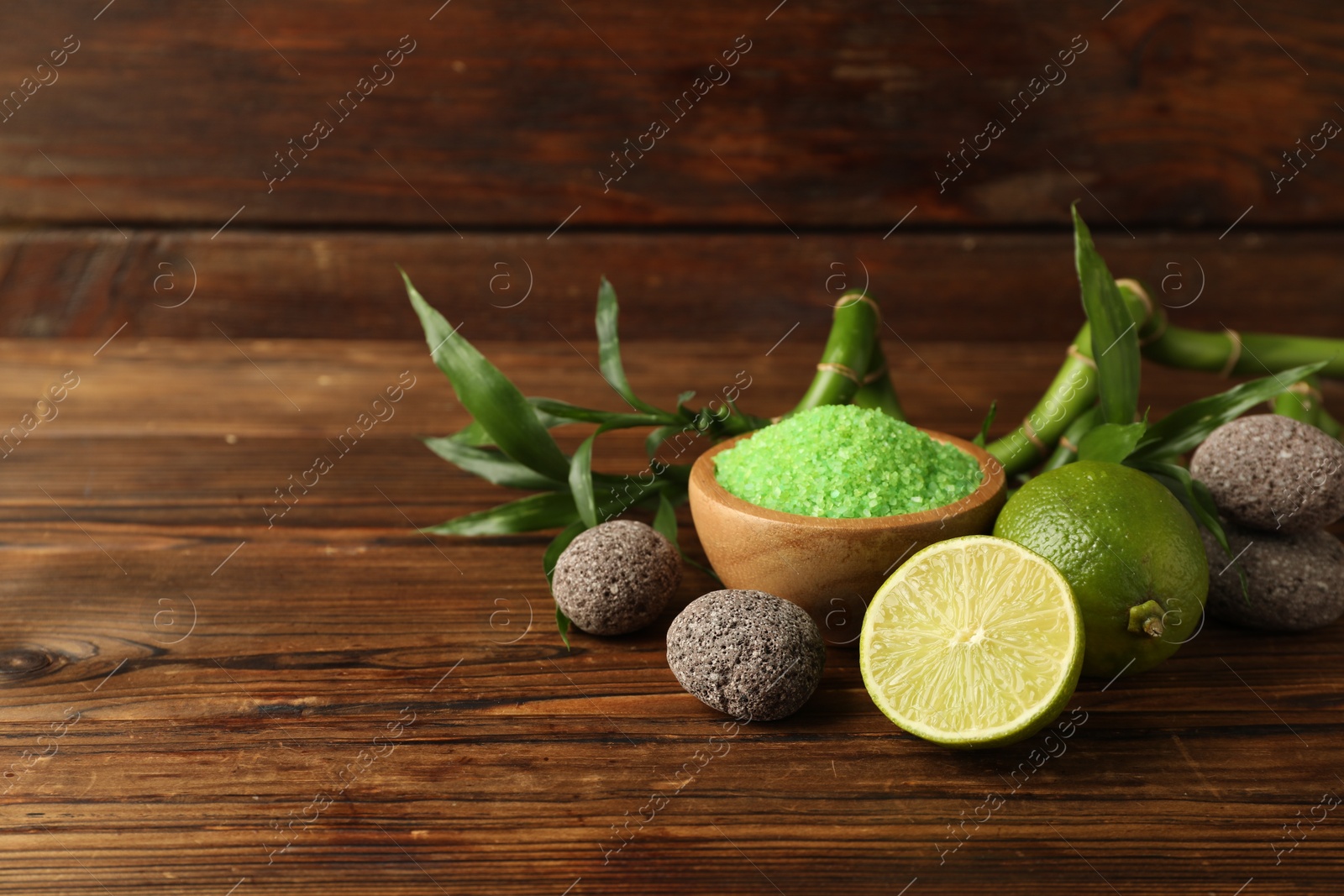 Spa composition with fresh limes, sea salt, stones and bamboo on wooden table. Space for text Photo of Spa composition with fresh limes, sea salt, stones and bamboo on wooden table. Space for text