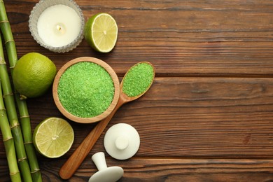 Photo of Spa composition with fresh limes, sea salt and bamboo stems on wooden table, flat lay. Space for text