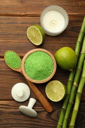 Photo of Spa composition with fresh limes, sea salt and bamboo stems on wooden table, flat lay