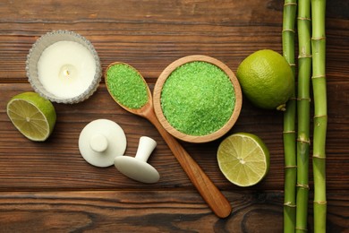 Photo of Spa composition with fresh limes, sea salt and bamboo stems on wooden table, flat lay