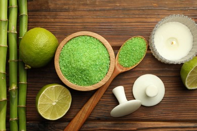 Photo of Spa composition with fresh limes, sea salt and bamboo stems on wooden table, flat lay