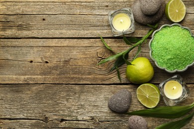 Photo of Spa composition with fresh limes, sea salt and burning candles on wooden table, flat lay. Space for text