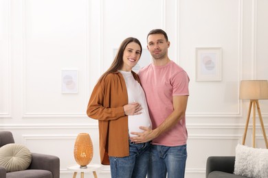 Pregnant woman and her husband at home