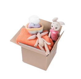 Photo of Different used clothes and toys in box isolated on white