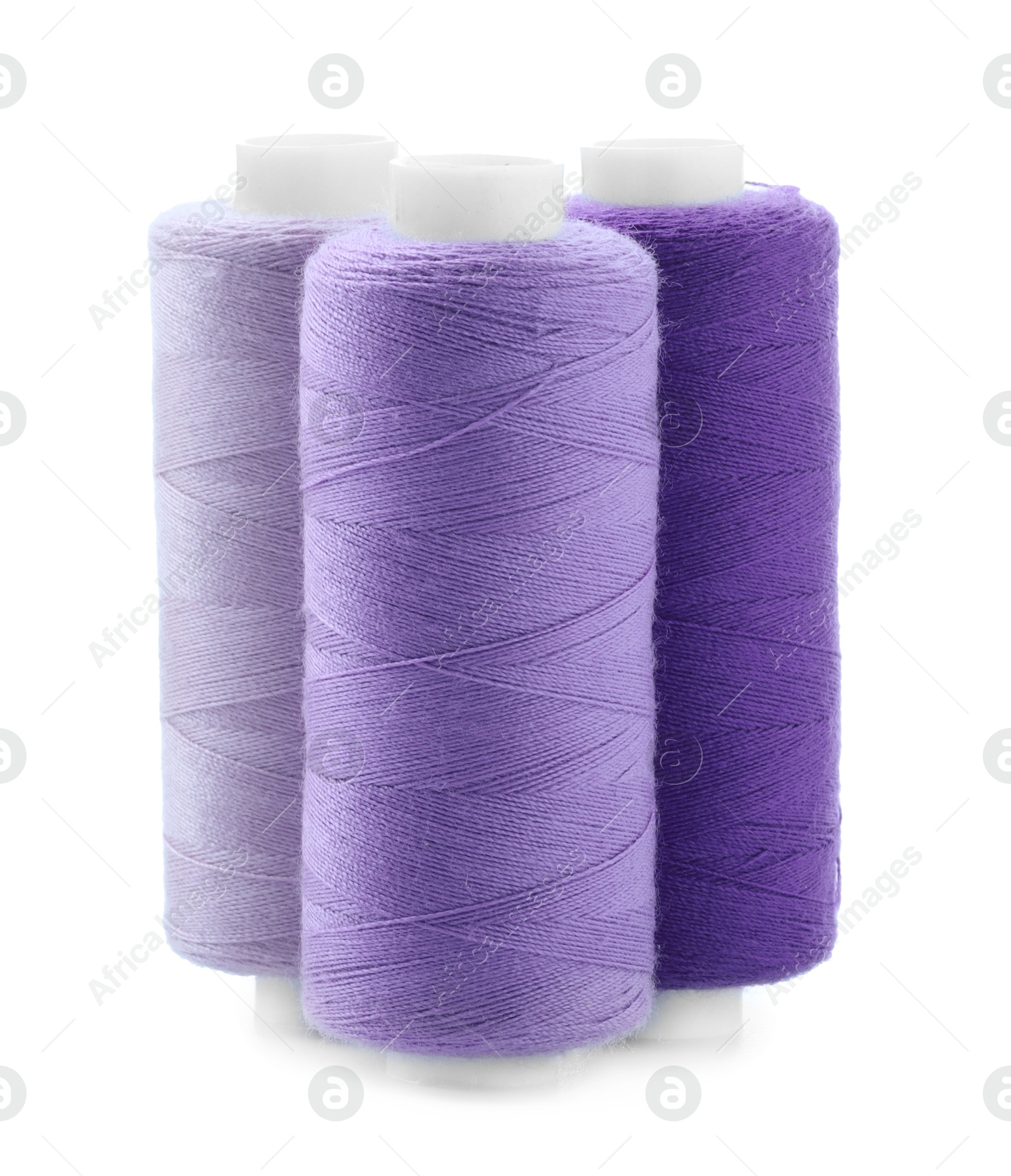 Photo of Spools of colorful sewing threads isolated on white