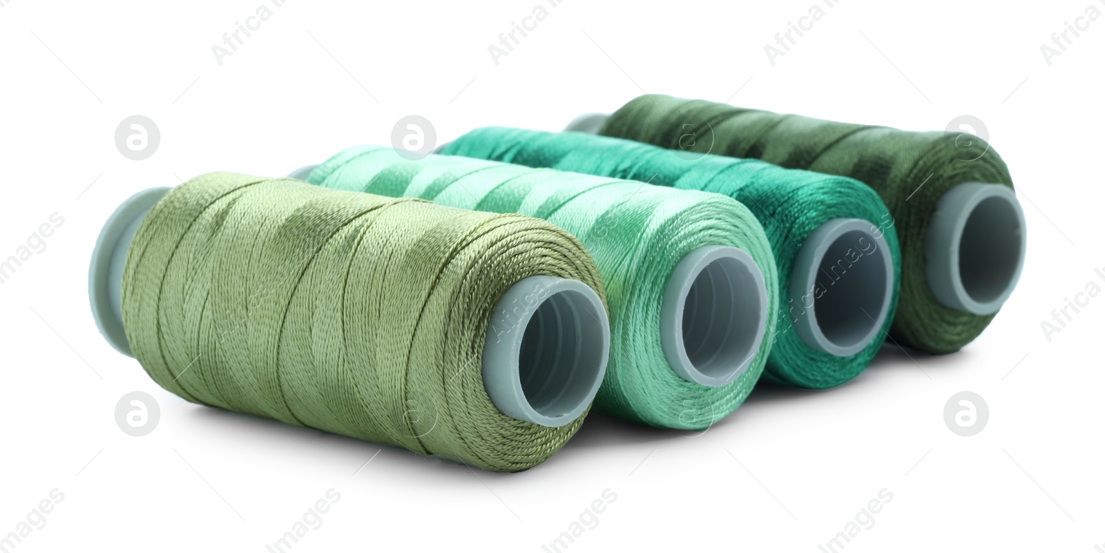 Photo of Spools of colorful sewing threads isolated on white