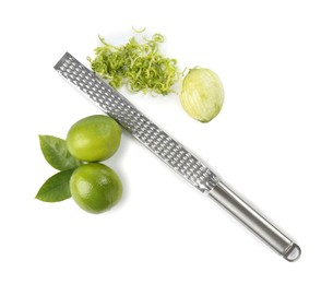 Photo of Lime zest, grater and fresh fruits isolated on white, top view