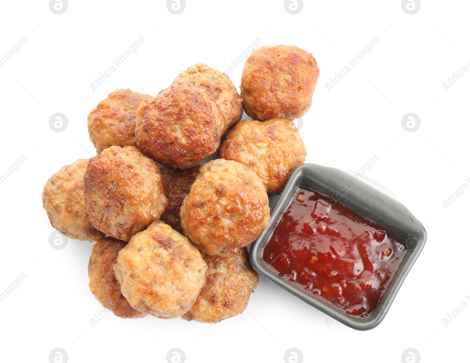 Photo of Pile of delicious meatballs and bowl with ketchup isolated on white, top view