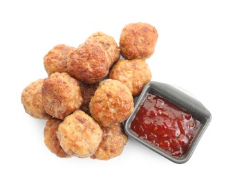 Photo of Pile of delicious meatballs and bowl with ketchup isolated on white, top view