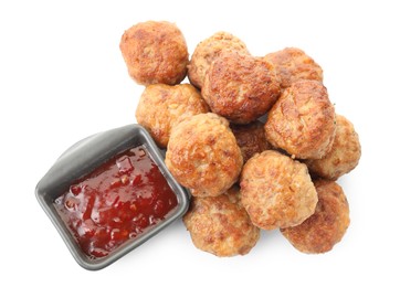 Photo of Pile of delicious meatballs and bowl with ketchup isolated on white, top view