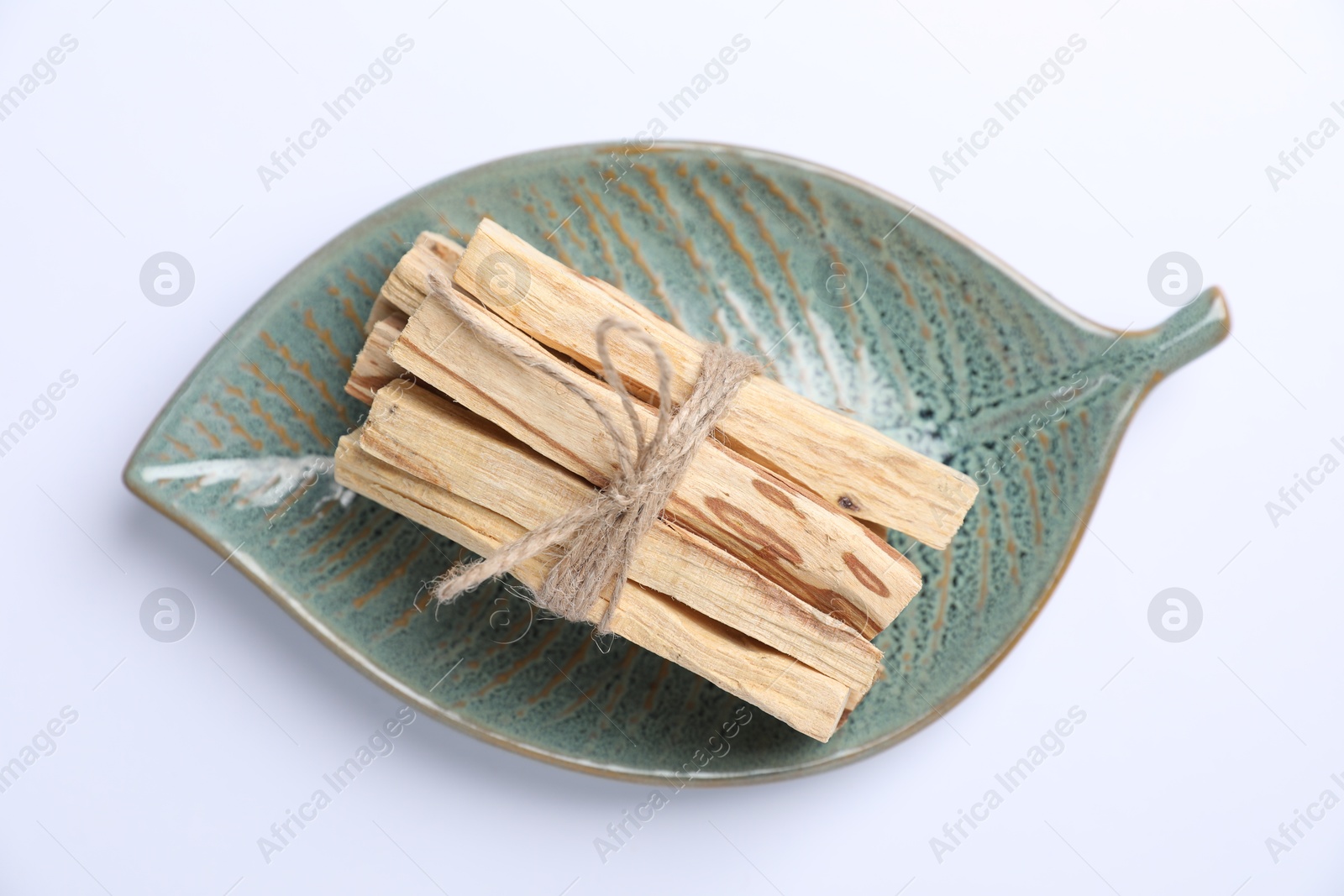 Photo of Bunch of palo santo sticks on white background, top view