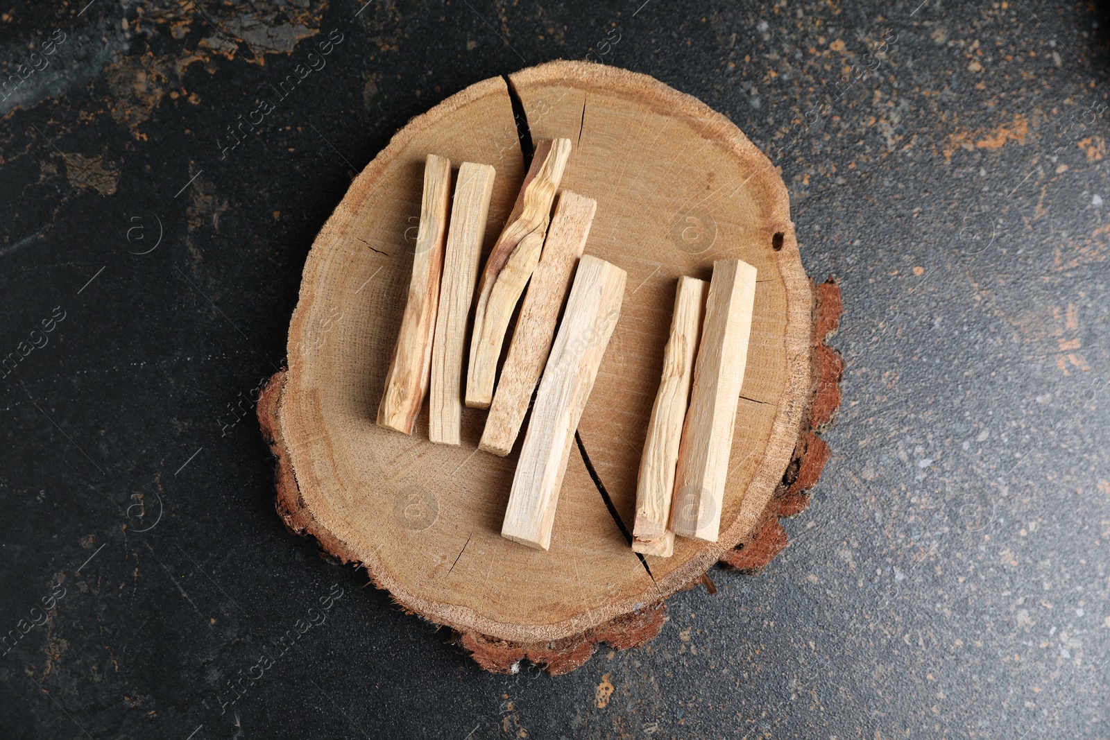 Photo of Palo santo sticks on dark table, top view