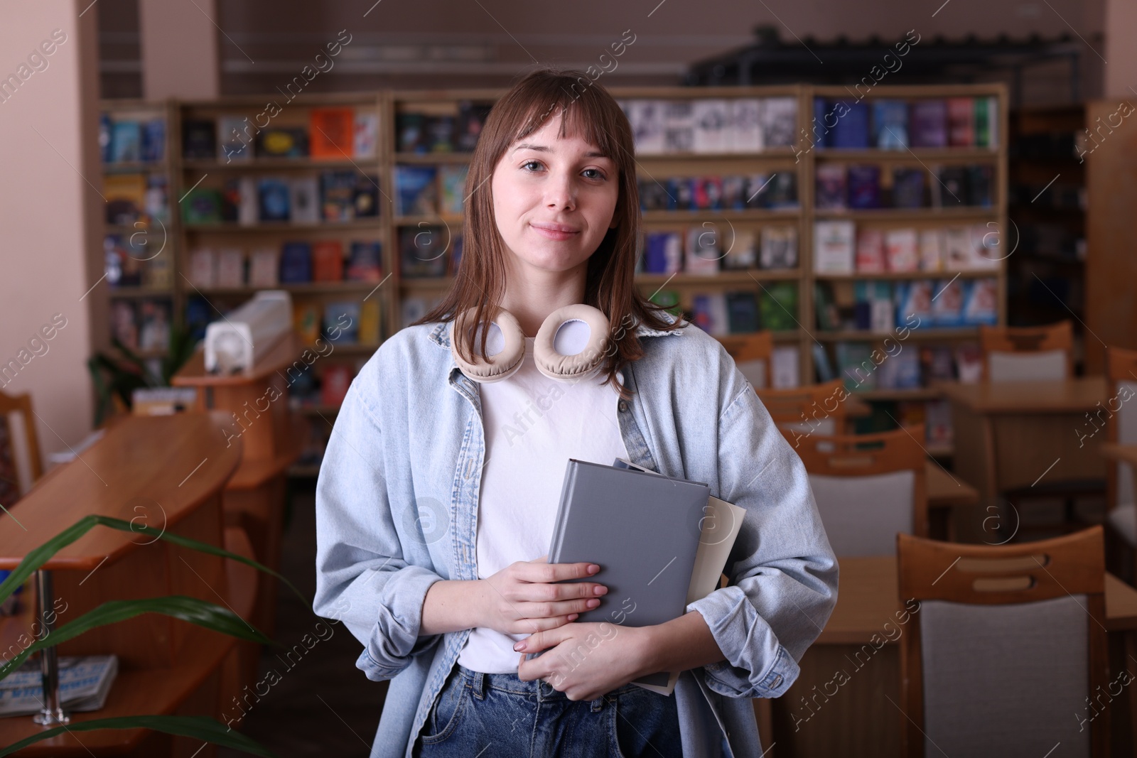 Photo of Portrait of beautiful woman with books in library