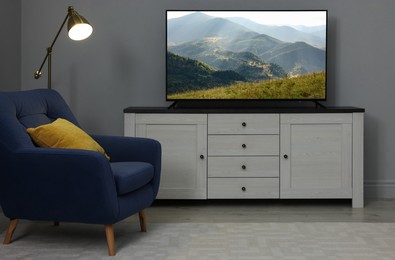 Image of TV set with nature landscape on screen in room