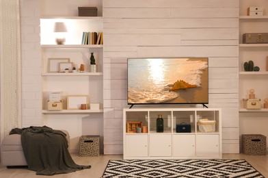 Image of TV set with nature landscape on screen in room