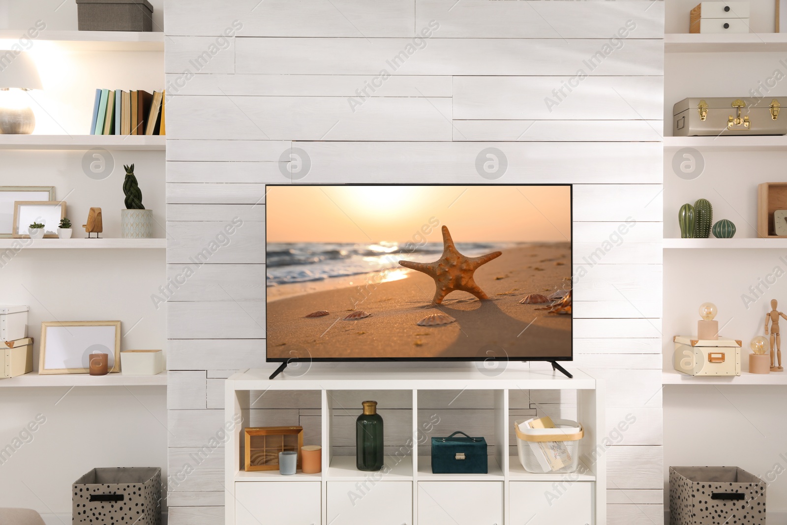 Image of TV set with nature landscape on screen in room