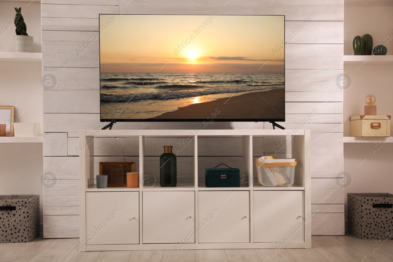 Image of TV set with nature landscape on screen in room