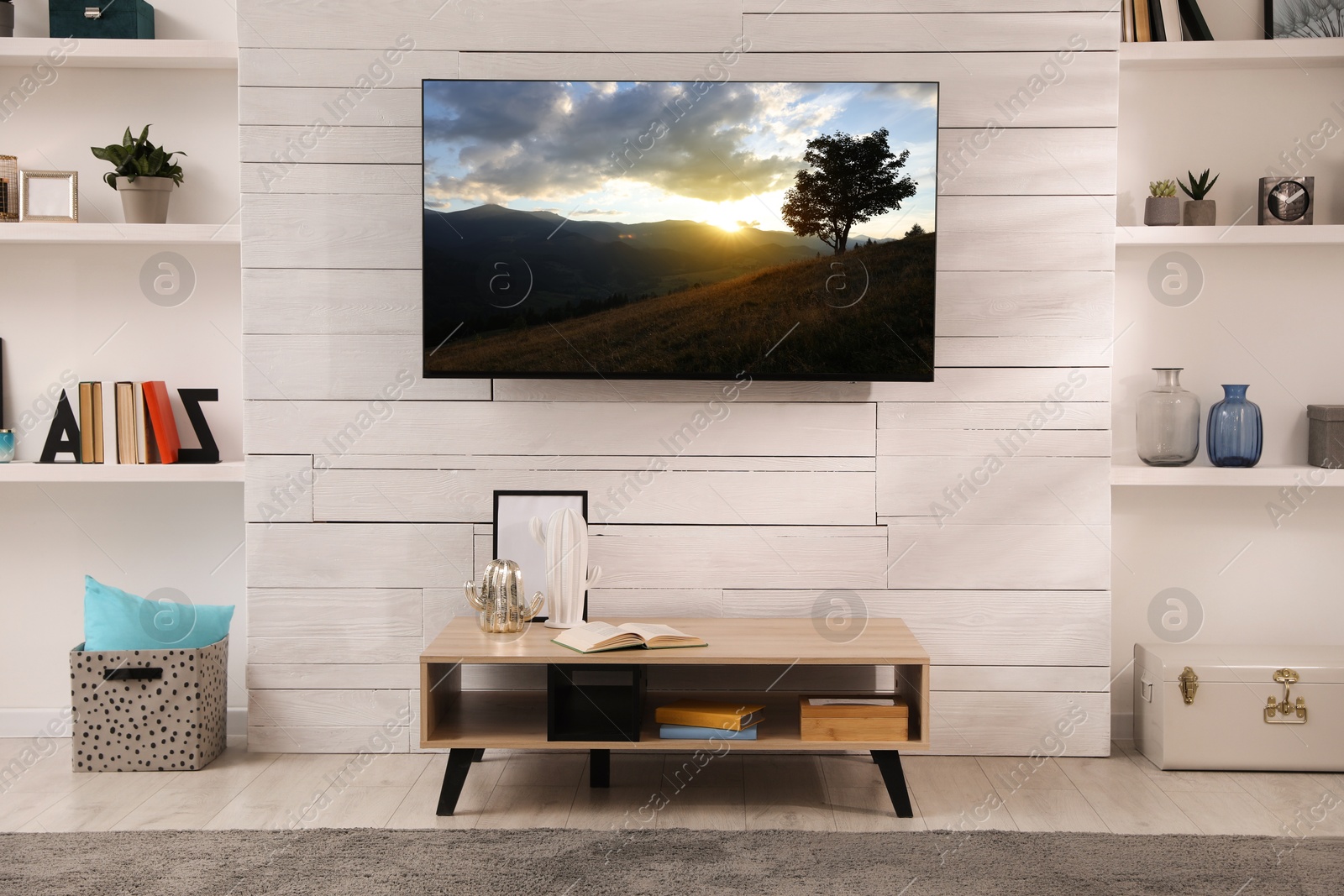 Image of TV set with nature landscape on screen in room