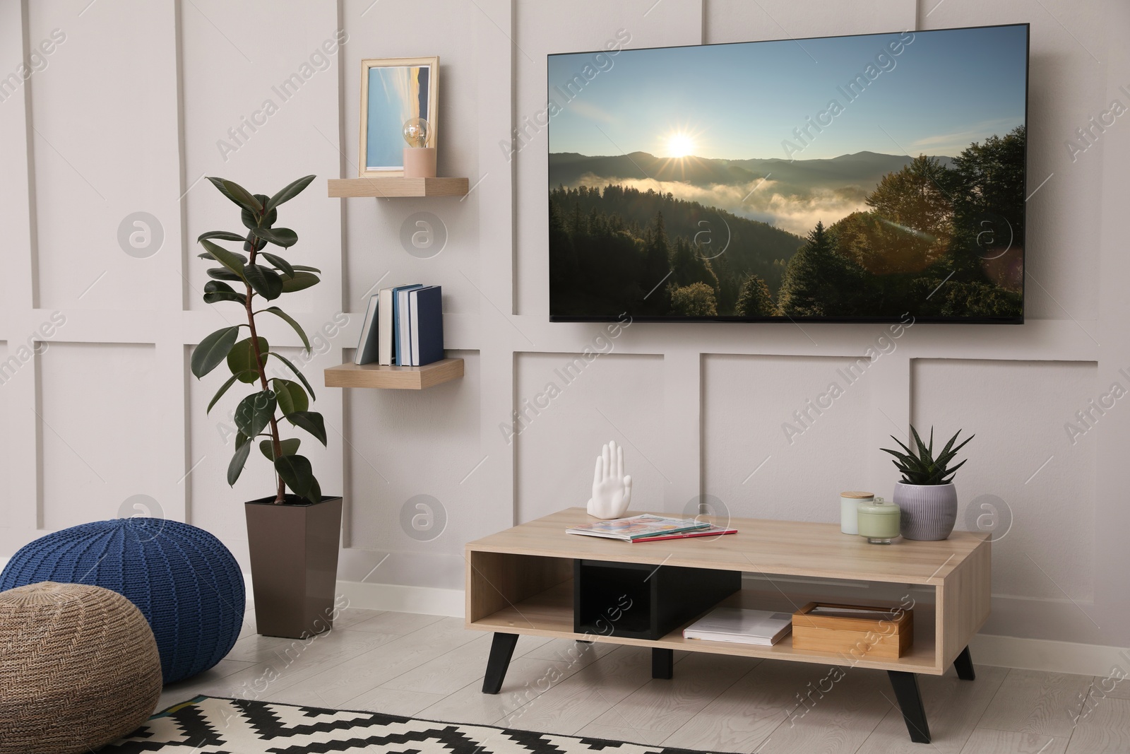 Image of TV set with nature landscape on screen in room