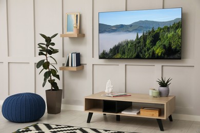 Image of TV set with nature landscape on screen in room