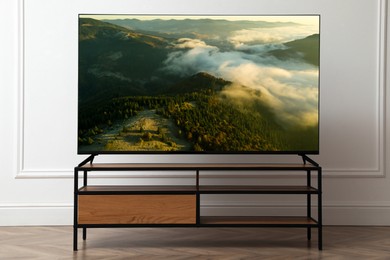 Image of TV set with nature landscape on screen in room