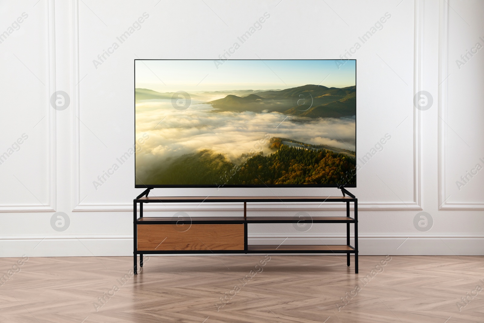 Image of TV set with nature landscape on screen in room