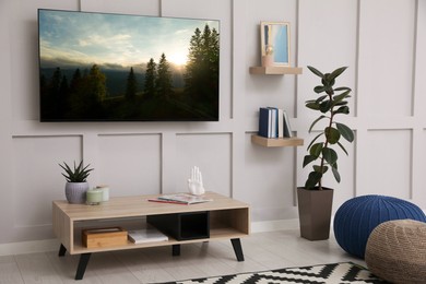 Image of TV set with nature landscape on screen in room